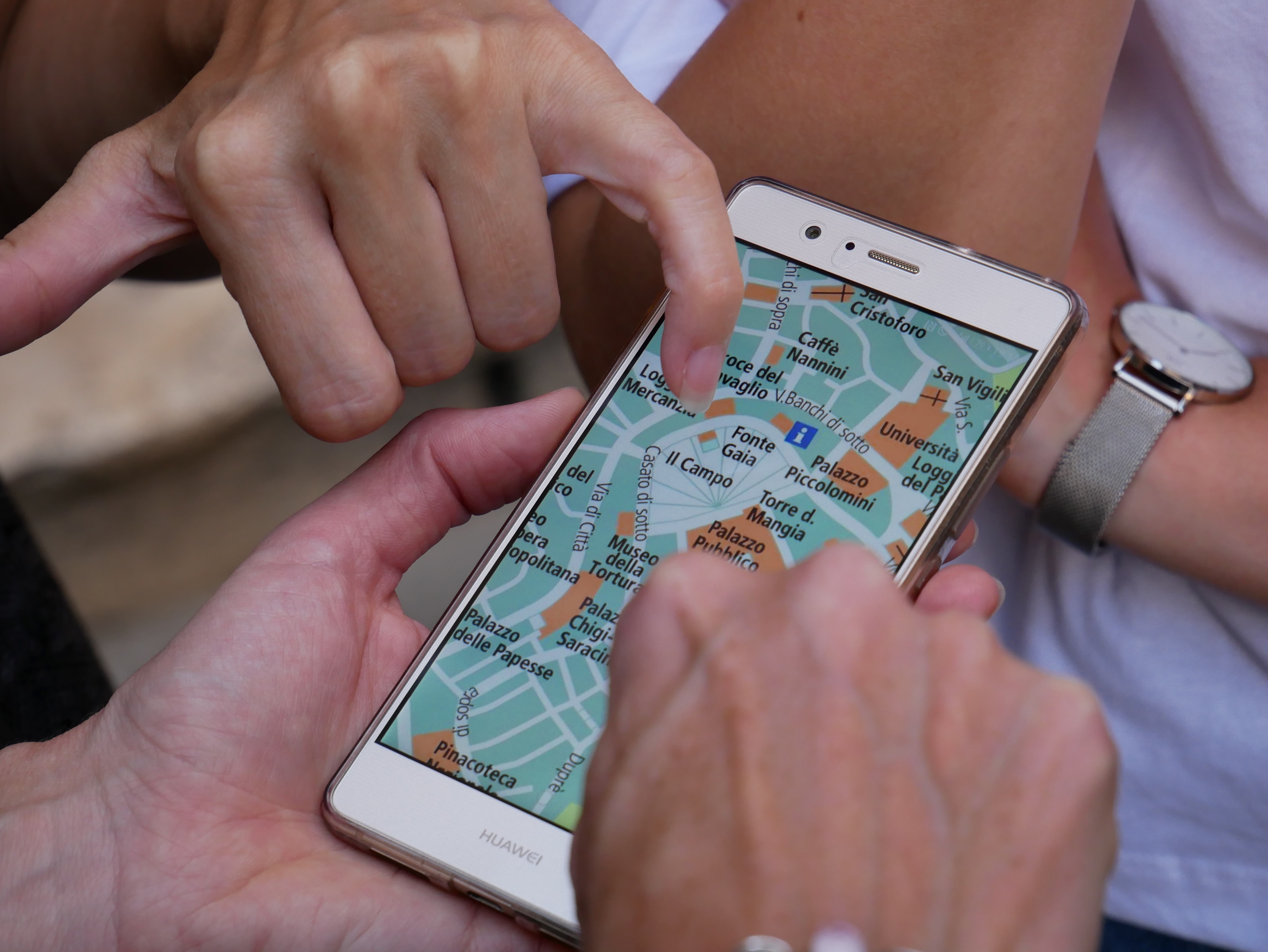 people looking on a map on a mobile phone